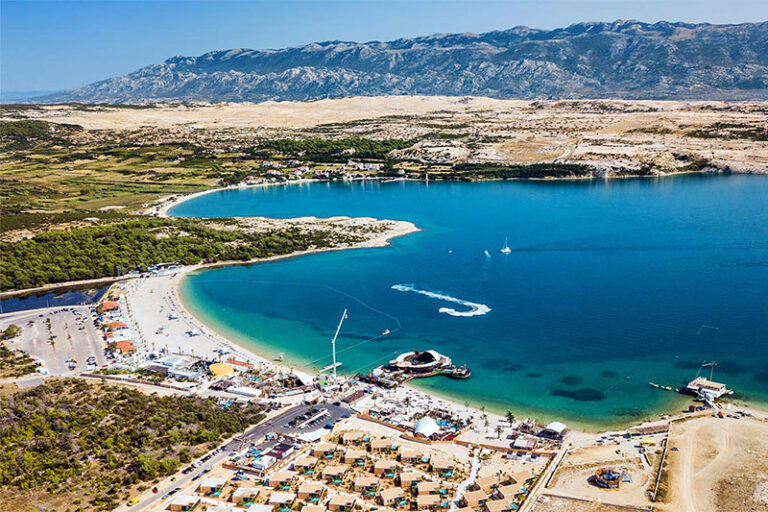 Aerial view of Zrće beach and its clubs near Novalja, with the Velebit mountains behind