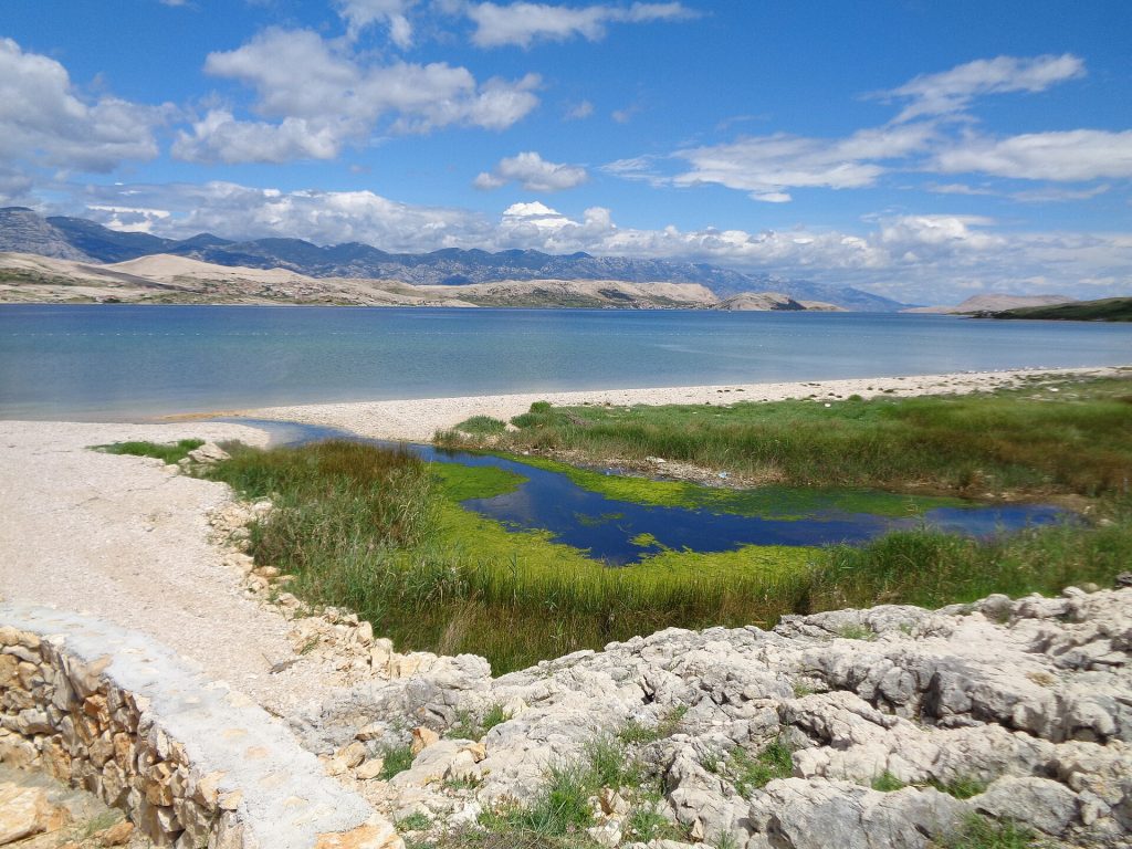 Clear shallow water and pebbles at Cista beach near Kolan, island of Pag